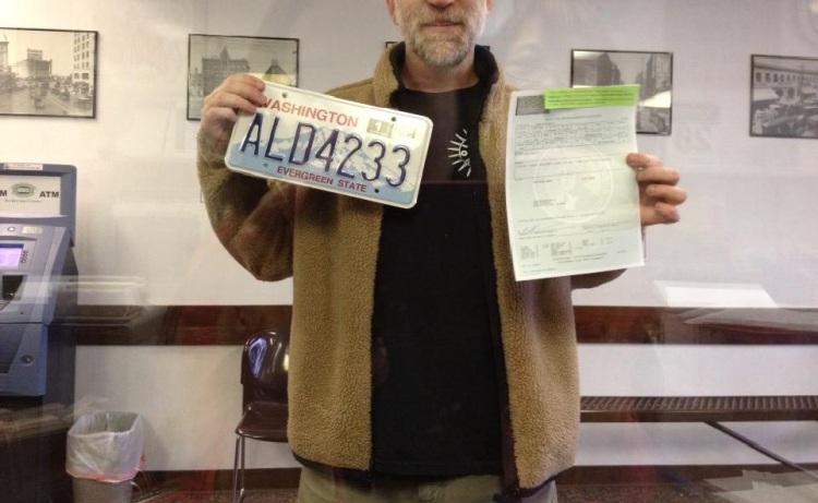 Check the glare from the plexiglass! DMV Clerk took this photo of the Happy BJ60 Owner and his New Plates